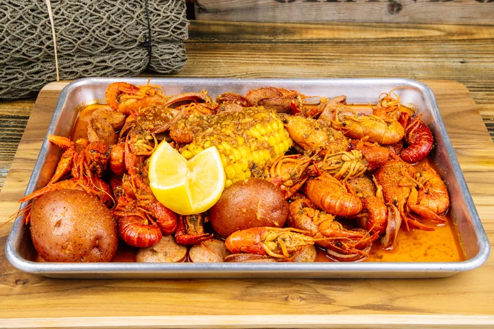 Crawfish boil with corn, potatoes, and lemon